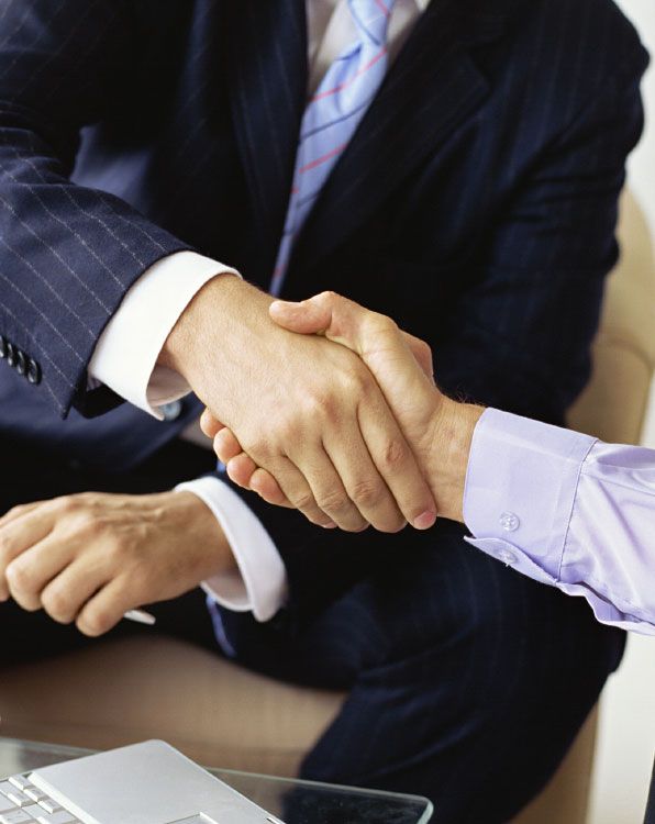 A picture of two employees giving handshake