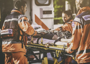 Paramedic team helping injured person