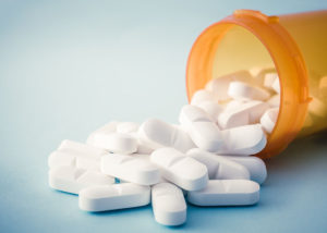 A picture of the tablets spilling out from bottle