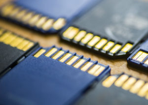 A large group of SD cards on the wooden table